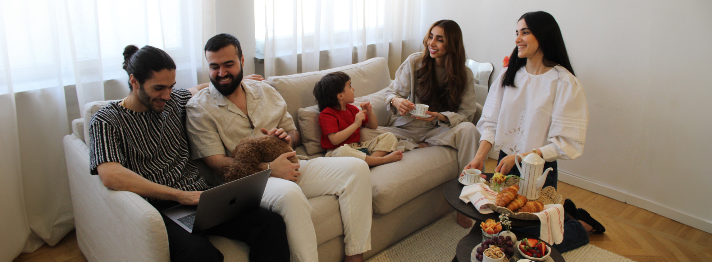 Shabnam with family in peyton sofa.